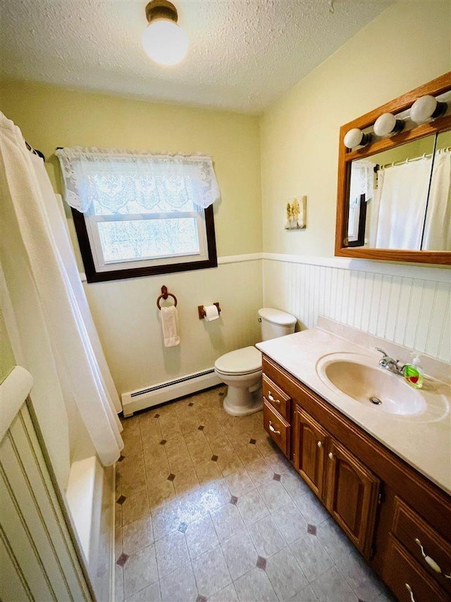 1368 S M-88, Bellaire, MI 49615 - full bathroom with wainscoting, a baseboard radiator, a textured ceiling, and vanity