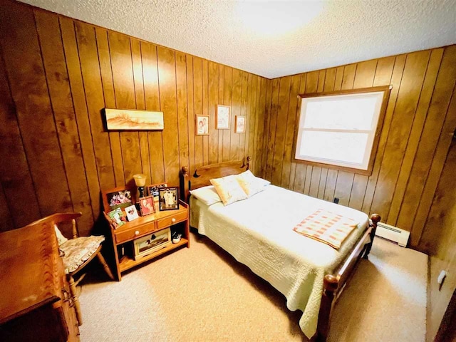 1368 S M-88, Bellaire, MI 49615 - bedroom featuring a baseboard radiator, a textured ceiling, carpet, and wood walls