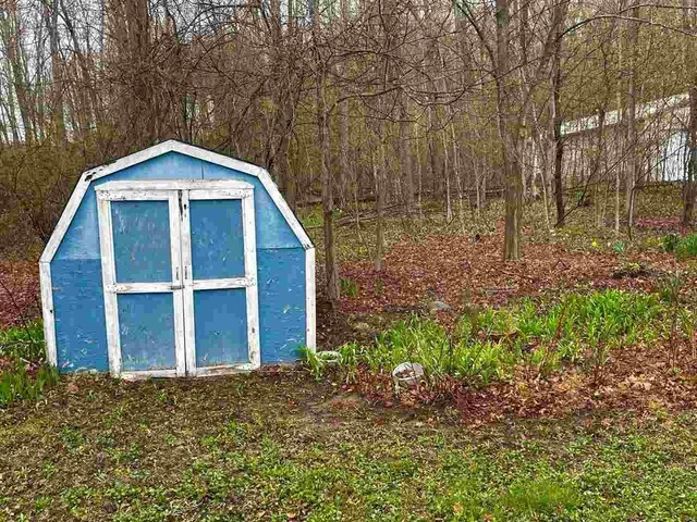 1368 S M-88, Bellaire, MI 49615 - view of shed featuring a view of trees