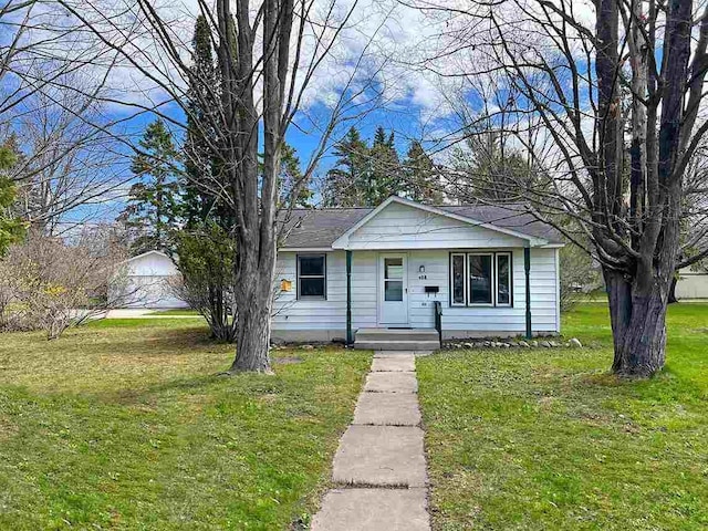 bungalow-style home with a front yard and covered porch