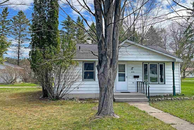 bungalow-style house featuring a front yard