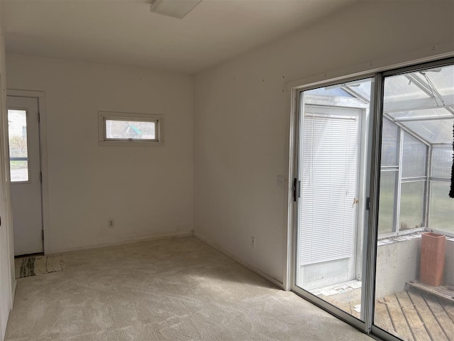 empty room with light colored carpet and healthy amount of natural light