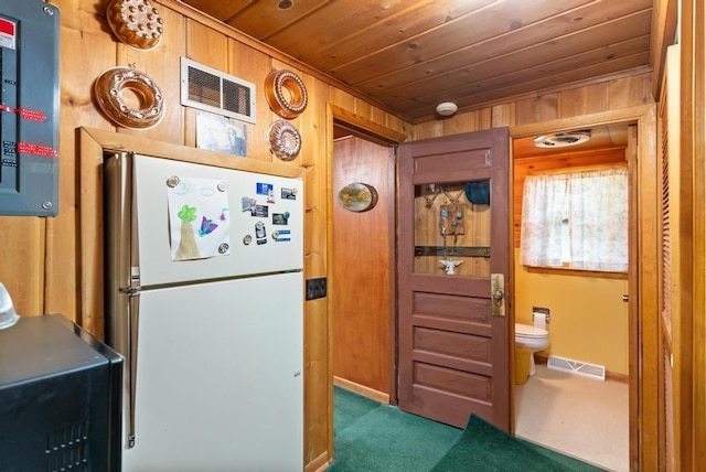 14786 Nuenfelt Rd, Johannesburg, MI 49756 - kitchen featuring freestanding refrigerator, wood ceiling, carpet floors, wooden walls, and baseboards