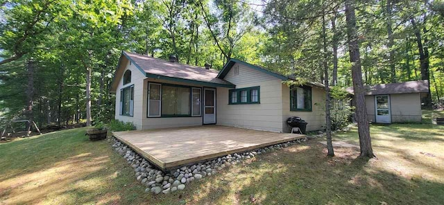 14786 Nuenfelt Rd, Johannesburg, MI 49756 - rear view of house with a wooden deck and a lawn