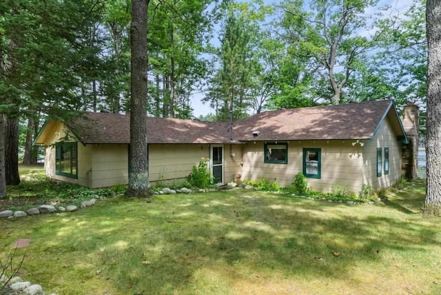 14786 Nuenfelt Rd, Johannesburg, MI 49756 - single story home with a front lawn, a chimney, and roof with shingles