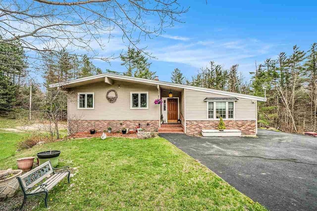 3414 Reycraft Rd, Boyne City, MI 49712 - view of front of property featuring a front yard, brick siding, and driveway