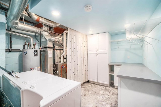 3414 Reycraft Rd, Boyne City, MI 49712 - laundry area featuring cabinet space, gas water heater, washer and dryer, and heating unit