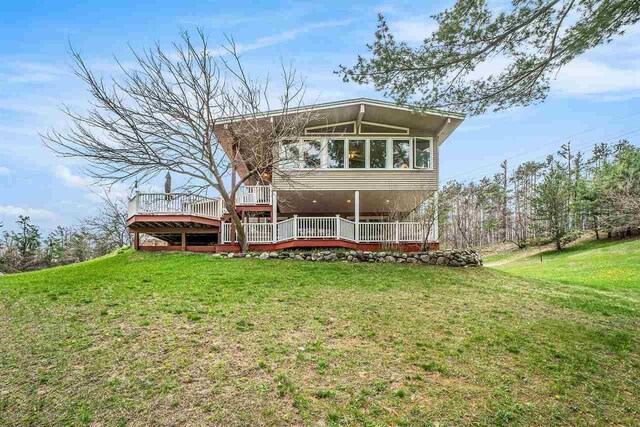 3414 Reycraft Rd, Boyne City, MI 49712 - rear view of house with a deck and a lawn