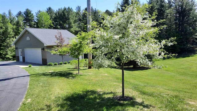 3414 Reycraft Rd, Boyne City, MI 49712 - view of front facade featuring a garage, a front yard, and driveway