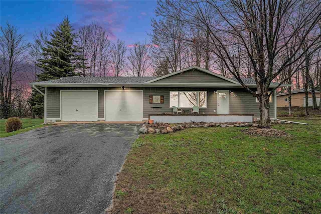 110 Hillcrest, East Jordan, MI 49727 - ranch-style house with a garage, asphalt driveway, and a lawn