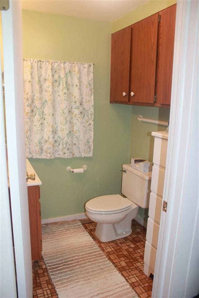 half bathroom featuring toilet and vanity