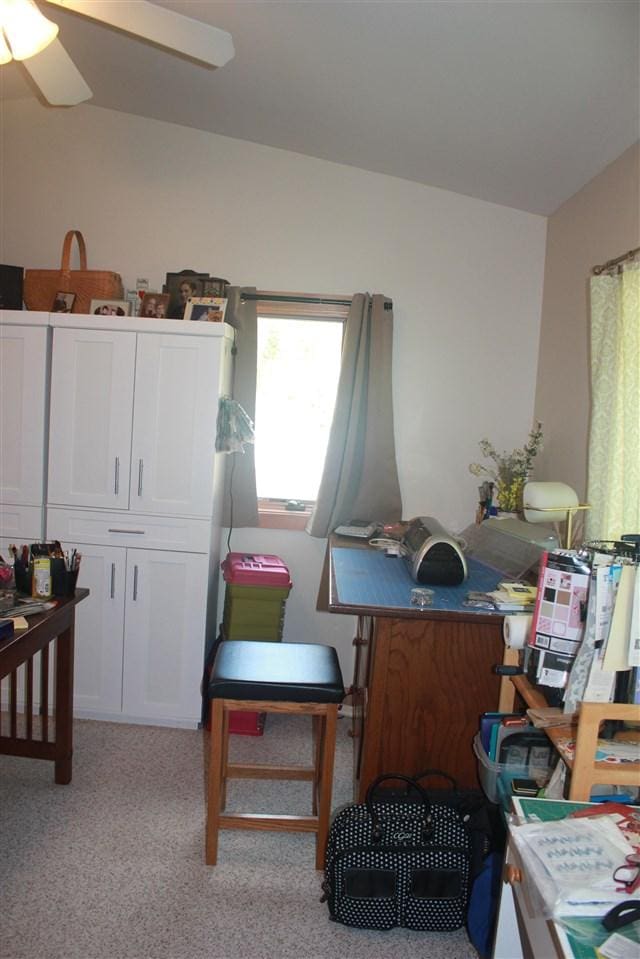 office area with ceiling fan and light carpet