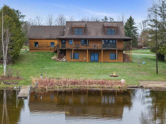 8120 Susan Shore Dr, Charlevoix, MI 49720 - back of house with an outdoor fire pit, a yard, and a deck with water view
