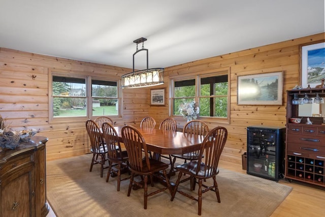 8120 Susan Shore Dr, Charlevoix, MI 49720 - dining room with wooden walls, healthy amount of natural light, and light wood-style flooring