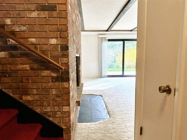 doorway with carpet floors and a fireplace