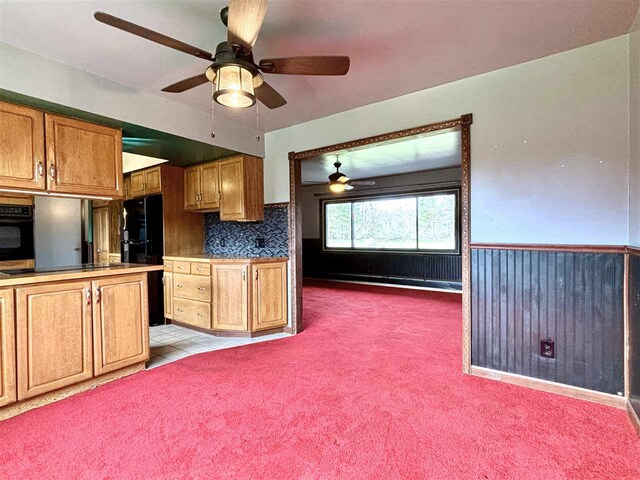 kitchen featuring black appliances, a ceiling fan, and brown cabinets