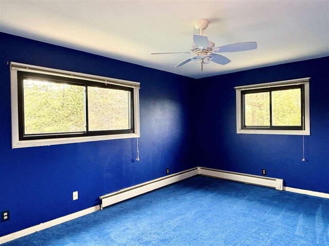 spare room with healthy amount of natural light, carpet flooring, baseboards, and a ceiling fan