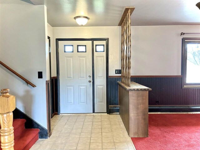 entrance foyer with a wainscoted wall and stairs