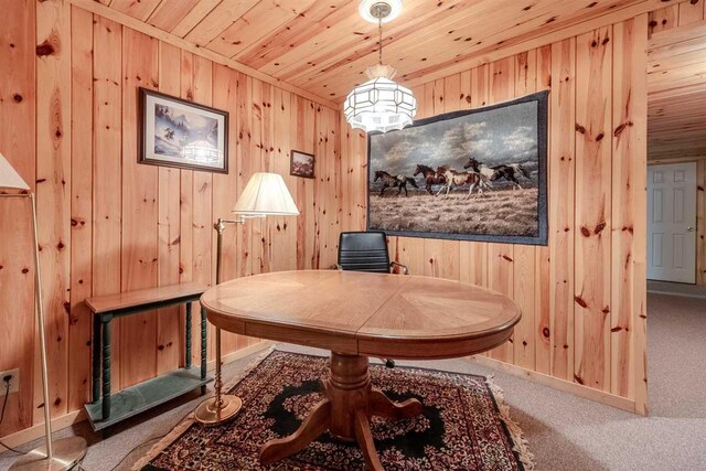 carpeted home office featuring wood ceiling, wood walls, and baseboards