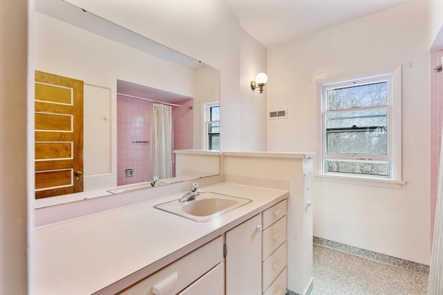 619 Kalamazoo Ave, Petoskey, MI 49770 - full bathroom with speckled floor, baseboards, vanity, and a shower with curtain