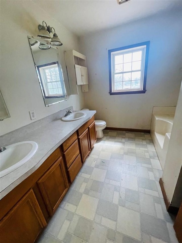 204 E Forest Home Ave, Bellaire, MI 49615 - bathroom with toilet, double vanity, and tile patterned floors