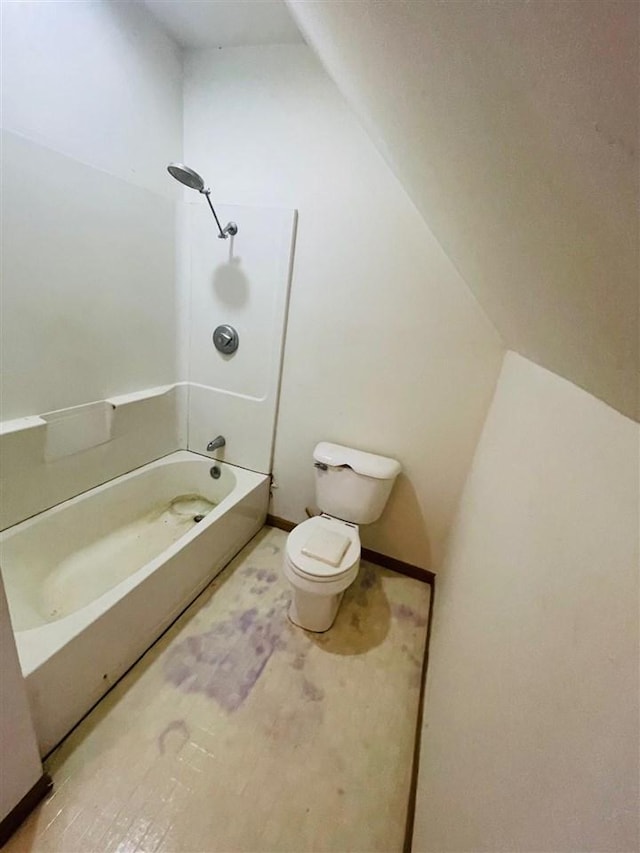 204 E Forest Home Ave, Bellaire, MI 49615 - bathroom with toilet, washtub / shower combination, vaulted ceiling, and baseboards
