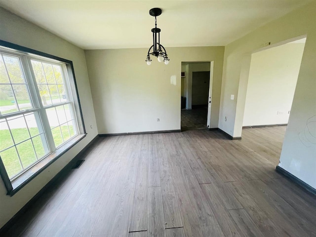 204 E Forest Home Ave, Bellaire, MI 49615 - unfurnished dining area featuring baseboards and wood finished floors
