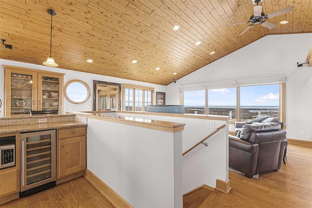 4133 Shadynook Rd, Central Lake, MI 49622 - kitchen with wine cooler, wooden ceiling, high vaulted ceiling, baseboards, and light wood-type flooring