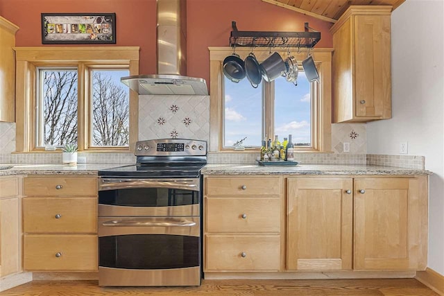 4133 Shadynook Rd, Central Lake, MI 49622 - kitchen with double oven range, light brown cabinets, ventilation hood, vaulted ceiling, and decorative backsplash