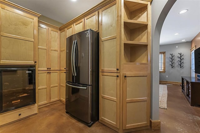 4133 Shadynook Rd, Central Lake, MI 49622 - kitchen featuring freestanding refrigerator, concrete flooring, light brown cabinets, arched walkways, and oven