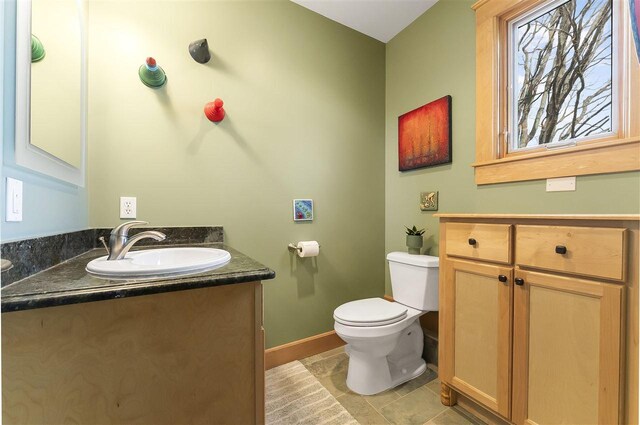 4133 Shadynook Rd, Central Lake, MI 49622 - half bathroom with vanity, toilet, tile patterned floors, and baseboards