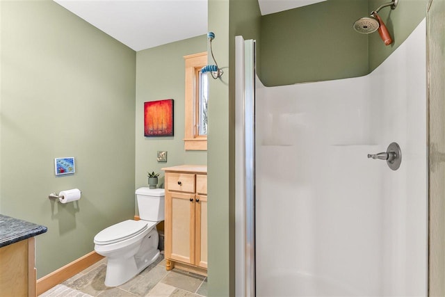 4133 Shadynook Rd, Central Lake, MI 49622 - bathroom featuring vanity, toilet, a stall shower, and baseboards