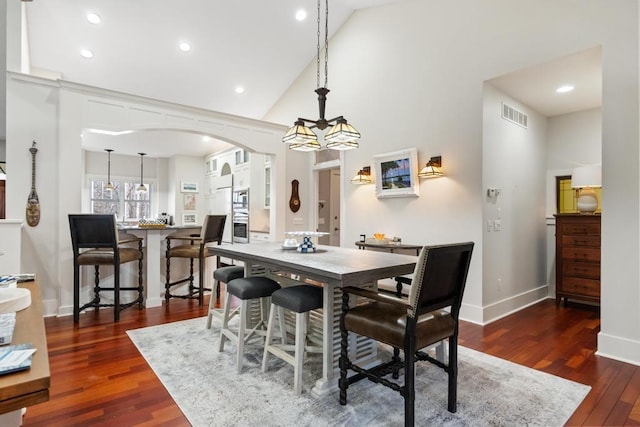 334 Birchwood Ter, Harbor Springs, MI 49740 - dining area featuring arched walkways, wood finished floors, recessed lighting, baseboards, and high vaulted ceiling