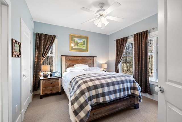 334 Birchwood Ter, Harbor Springs, MI 49740 - bedroom with light colored carpet, a ceiling fan, and baseboards
