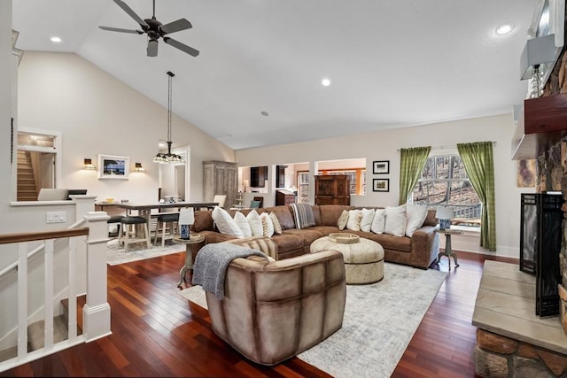 334 Birchwood Ter, Harbor Springs, MI 49740 - living area with ceiling fan, dark wood finished floors, a fireplace, stairway, and high vaulted ceiling