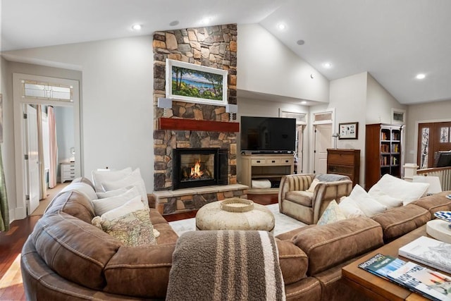 334 Birchwood Ter, Harbor Springs, MI 49740 - living room featuring lofted ceiling, a stone fireplace, wood finished floors, and recessed lighting