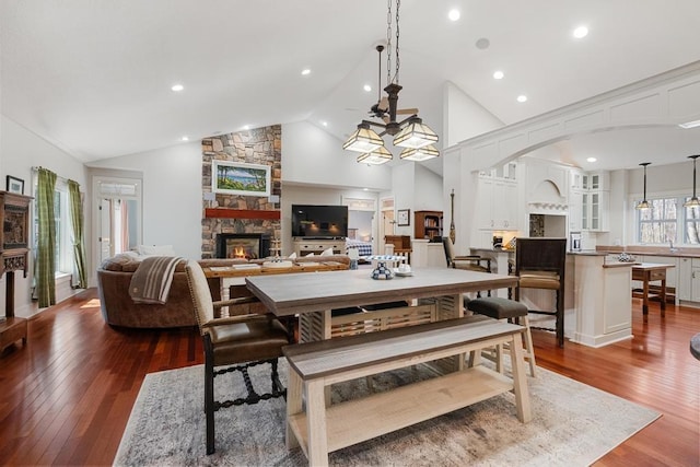 334 Birchwood Ter, Harbor Springs, MI 49740 - dining room with a fireplace, dark wood-style floors, recessed lighting, arched walkways, and high vaulted ceiling