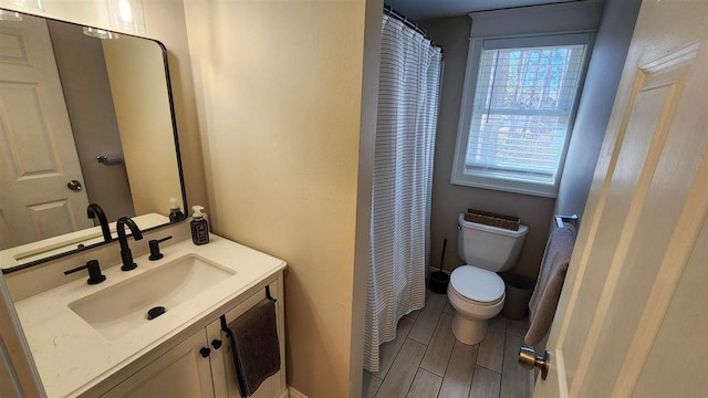 bathroom featuring toilet and vanity