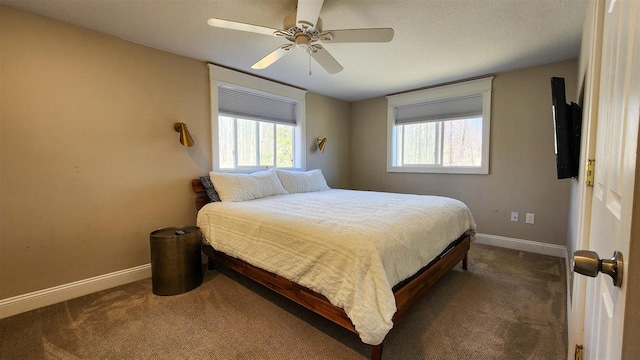 carpeted bedroom with baseboards, multiple windows, and ceiling fan