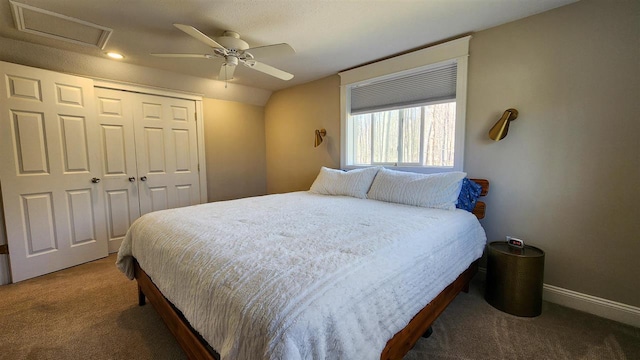carpeted bedroom with a ceiling fan, recessed lighting, attic access, a closet, and baseboards