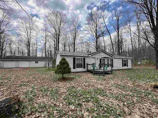 4049 Musser Rd, Mancelona, MI 49659 - manufactured / mobile home with a wooden deck and view of scattered trees
