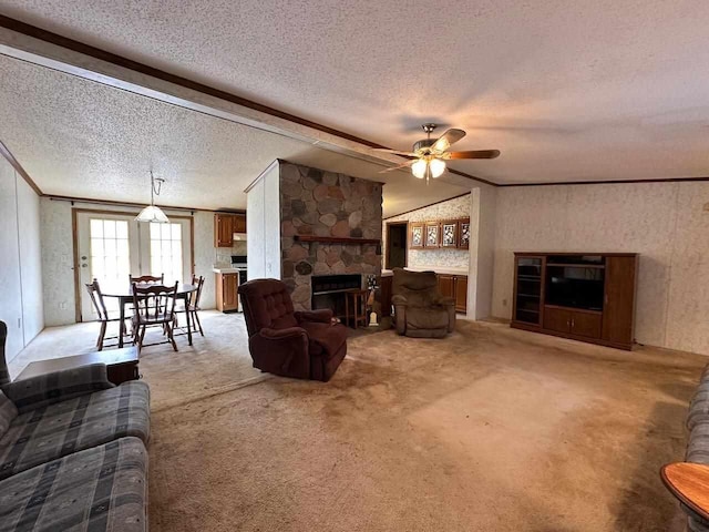 4049 Musser Rd, Mancelona, MI 49659 - living room featuring a fireplace, ceiling fan, light colored carpet, a textured ceiling, and crown molding