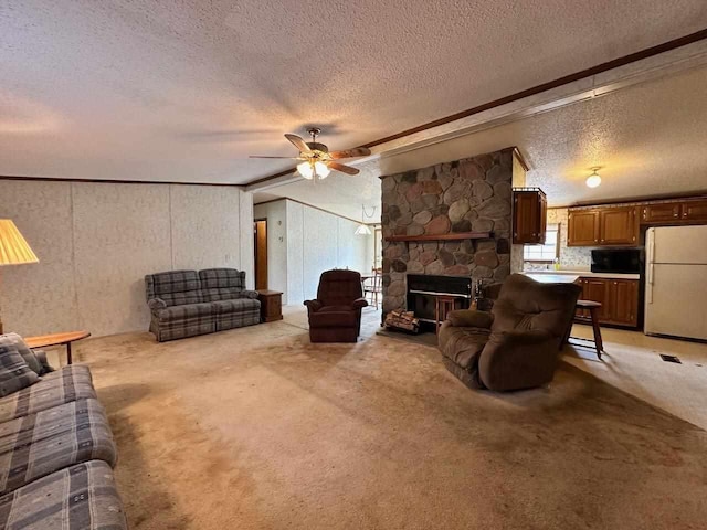 4049 Musser Rd, Mancelona, MI 49659 - living room with a textured ceiling, a ceiling fan, light colored carpet, crown molding, and a stone fireplace