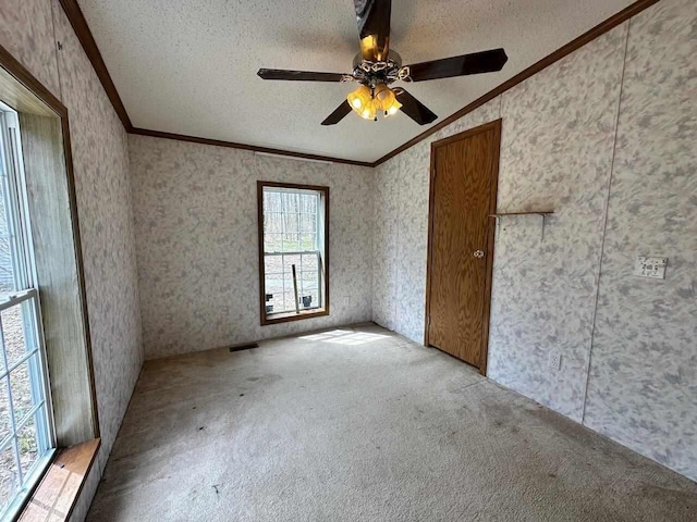 4049 Musser Rd, Mancelona, MI 49659 - carpeted empty room with vaulted ceiling, crown molding, a textured ceiling, wallpapered walls, and ceiling fan