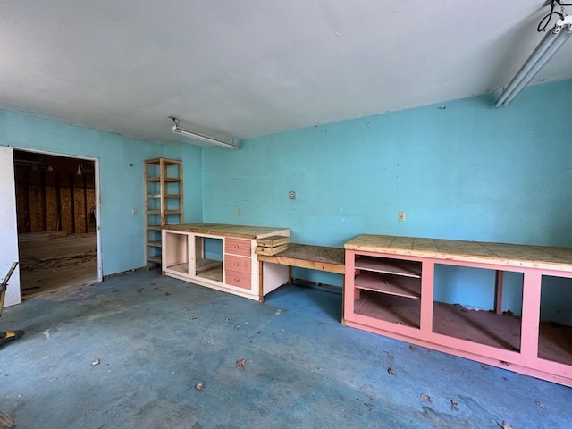 4049 Musser Rd, Mancelona, MI 49659 - misc room featuring a workshop area and unfinished concrete floors