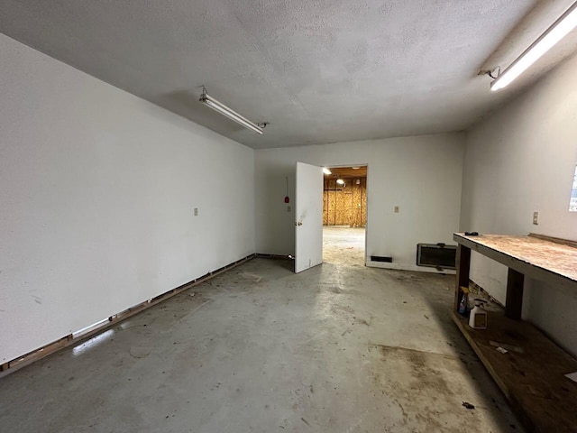 4049 Musser Rd, Mancelona, MI 49659 - spare room featuring concrete floors and a textured ceiling
