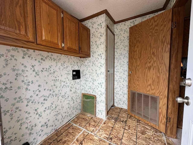 4049 Musser Rd, Mancelona, MI 49659 - laundry area with crown molding, wallpapered walls, and a textured ceiling