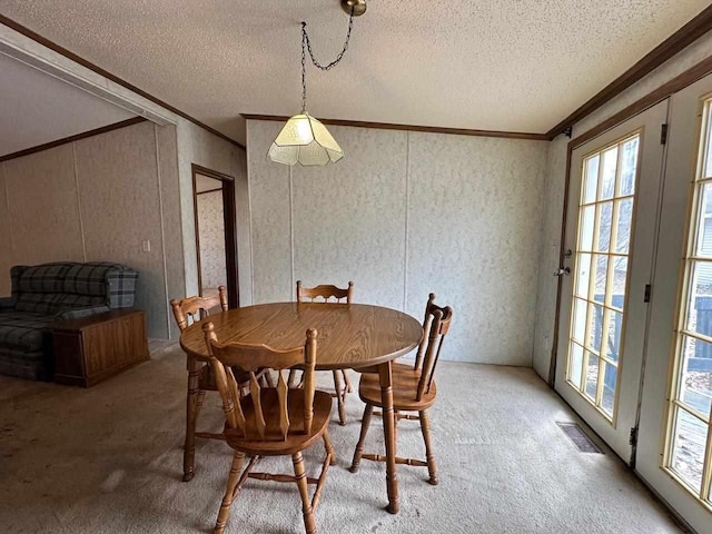 4049 Musser Rd, Mancelona, MI 49659 - dining area featuring crown molding, light colored carpet, and a textured ceiling