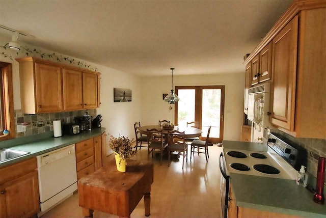 3330 Commodore Dr, East Jordan, MI 49727 - kitchen with white appliances, tasteful backsplash, track lighting, and brown cabinets