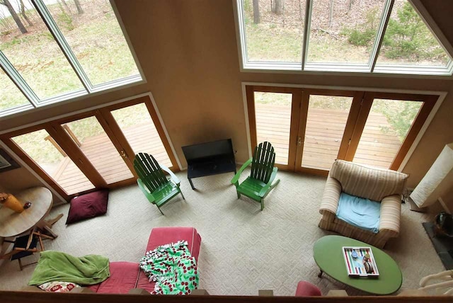 3330 Commodore Dr, East Jordan, MI 49727 - carpeted living room with french doors and a high ceiling